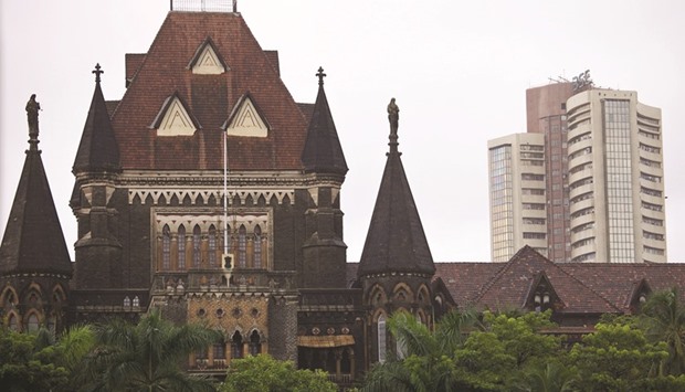 The Bombay Stock Exchange (right) is seen behind the Bombay High Court building in Mumbai. The BSE Sensex closed down 443.71 points to 28,353.54 yesterday.