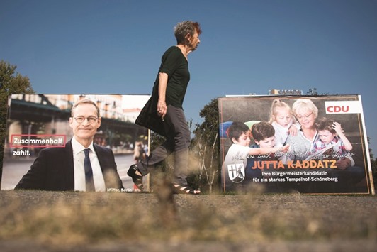 Election posters depicting the incumbent mayor of Berlin, Michael Muller of the Social Democrats and CDU candidate Jutta Kaddatz  in the neighbourhood of Schoeneberg in Berlin.