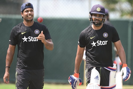 File picture of Indian cricketers Rohit Sharma (R) and Umesh Yadav during a practice session. Both these players have been included for the New Zealand series.