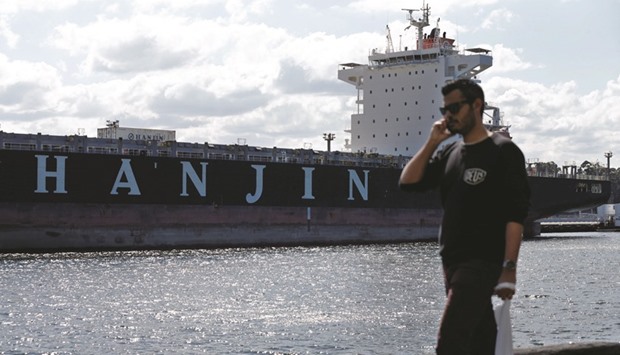 A pedestrian walks past the container ship Hanjin California moored to a dock in Sydney Harbour. Yesterday, Choi Eun-young, a former chairwoman of Hanjin pledged to provide $9mn in private funds to help resolve the situation in which economic damage is increasing from the turmoil in shipping due to its unexpected court restructuring.