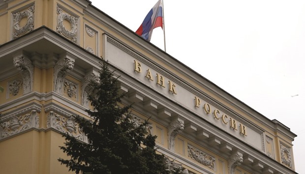 A Russian national flag flies over the central bank headquarters in Moscow. The Bank of Russiau2019s goals are aligning with the governmentu2019s aim to shift to an investment-growth model after the crash in oil and the roubleu2019s crisis pushed the economy into the longest recession in two decades.