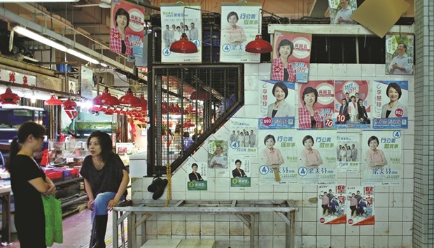 Small campaign posters for candidates to the Legislative Council election are displayed at a market in Hong Kong.