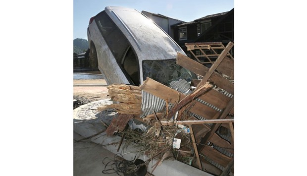A car that ploughed into a house is seen yesterday after Typhoon Lionrock made landfall in Iwaizumi, Iwate prefecture.