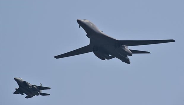 A US B-1B Lancer is escorted by South Korean F-15K fighter jets as it flies over the Osan Air Base, aiming at reinforcing the US commitment to its key ally in Pyeongtaek on Tuesday.