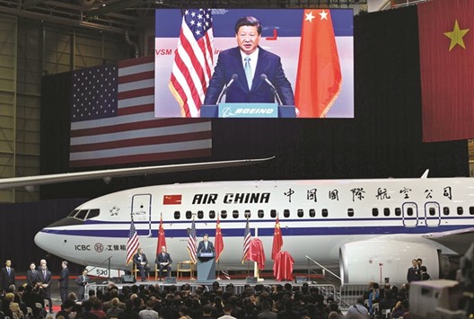 A Boeing 737 aircraft in Air China livery as Chinese President Xi Jinping (right, on podium) speaks beside Ray Conner, president and CEO of the Boeing Commercial Airplanes (left), and Dennis Muilenburg, president and CEO of the Boeing (2nd from left), in Everett, Washington yesterday.