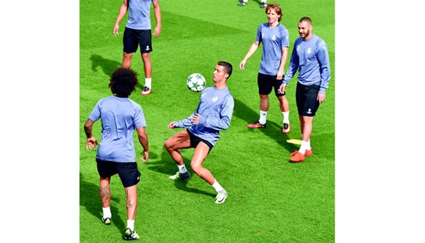 Real Madridu2019s Cristiano Ronaldo(centre) controls the ball as teammates Luka Modric (second from right) and Karim Benzema look on during a training session at Valdebebas training ground in Madrid yesterday. (AFP)