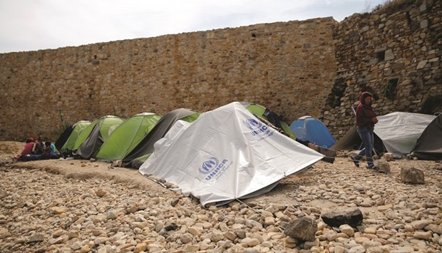 Tents are set on the beach next to a medieval fortification wall at the Souda municipality-run camp for refugees and migrants on the island of Chios, Greece.