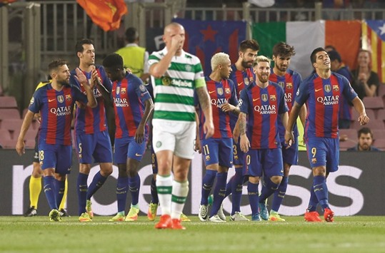 Lionel Messi (3rd from right) celebrates his hat-trick with teammates. Barcelona thrashed Celtic 7-0. (Reuters )