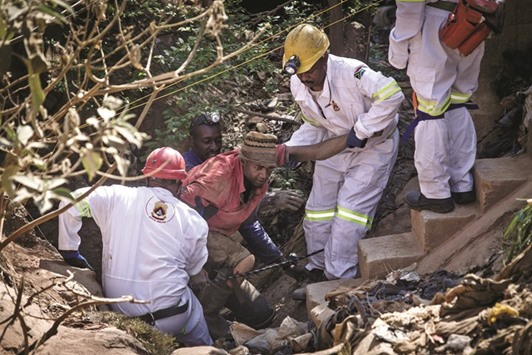 The Mine Rescue team helping pull an injured illegal miner out of the disused Langlaagte gold mine shaft entrance, where an unknown amount of u201cZama Zamasu201d (illegal miners) are trapped in Johannesburg.