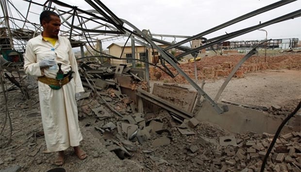 A Yemeni man inspects the damage to a factory allegedly targeted by Saudi-led airstrikes in Sanaa on Thursday.