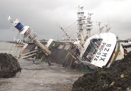 An overturned fishing boat is seen in the aftermath of Super Typhoon Meranti, at Sizihwan in Kaohsiung, Taiwan, yesterday.
