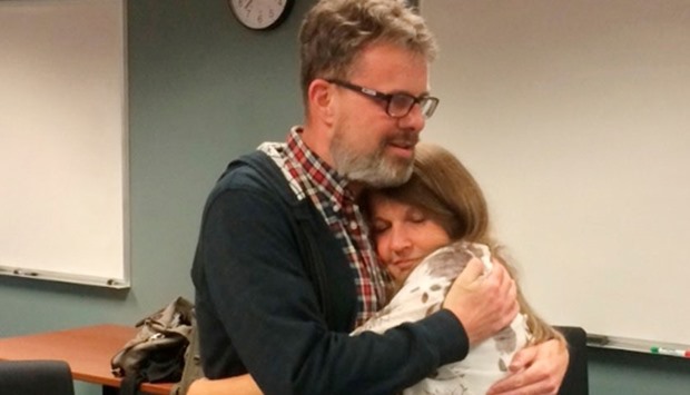 Kevin Garratt, a Canadian held in China for two years on suspicion of spying, hugs his wife Julia Garratt after being deported by Chinese authorities, in Vancouver, British Columbia, Canada