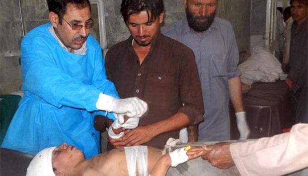 Pakistani paramedics treat an injured blast victim at a hospital in Bajaur Agency near the Pakistan-Afghanistan border on Friday, following a suicide bombing at a mosque in the Mohmand tribal district.
