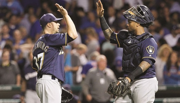Milwaukee Brewers relief pitcher Tyler Thornburg (left) celebrates with catcher Martin Maldonado after defeating the Chicago Cubs. (Jerry Lai-USA TODAY Sports)