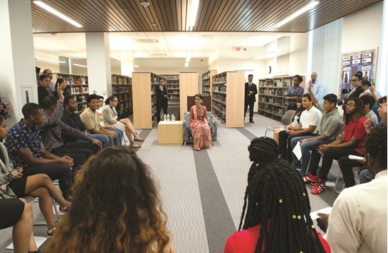 Suu Kyi with students taking part on Thursday in an educational programme in the library at Washingtonu2019s Roosevelt Senior High School.