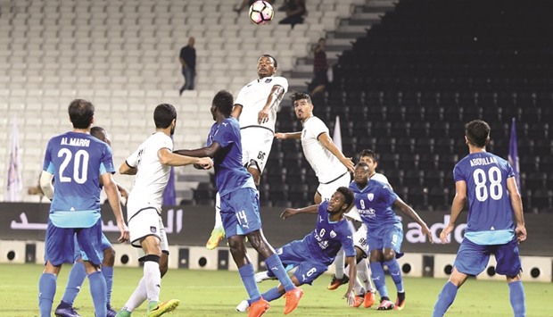 Al Saddu2019s Mohamed Kasola heads the ball to safety during his teamu2019s QSL match against Al Kharaitiyat yesterday. Pictures: Jayan Orma and Othman Iraqi
