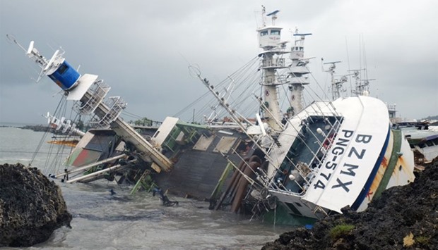 A general view shows an overturned fishing boat in the aftermath of super typhoon Meranti, at Sizihwan in Kaohsiung