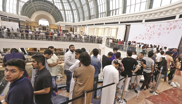 Customers queue outside an Apple store during the launch of the new iPhones yesterday at the Mall of the Emirates in Dubai.  Appleu2019s global iPhone launch was marked by excitement and frustration as fans queued to find scarce models of the coveted smartphone.