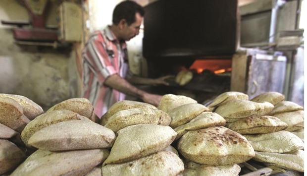 An Egyptian man prepares bread in a bakery in Cairo (file). Traders are refusing to offer wheat to Egypt, the worldu2019s biggest buyer of the grain, following the countryu2019s move to ban imports with traces of a naturally occurring fungus.