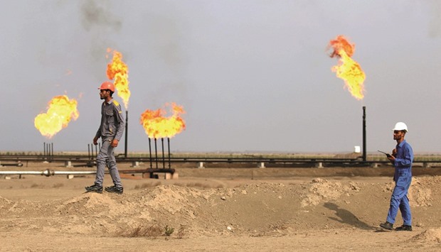 Iraqi labourers work at an oil refinery in the southern town Nasiriyah. The second-biggest producer in the Organisation of Petroleum Exporting Countries could support a freeze u201cfor a certain period,u201d Falah al-Amri, the director general of Iraqu2019s Oil Marketing Co, known as SOMO, said in an interview in Singapore.