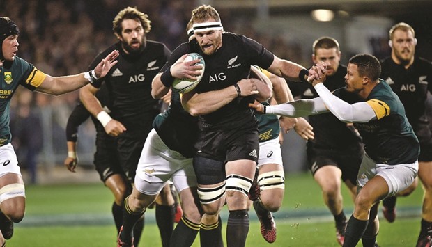 New Zealandu2019s captain Kieran Read (C) is tackled by South Africau2019s Vincent Koch (Back) and Juan de Jongh (R) during the rugby match at AMI Stadium in Christchurch.