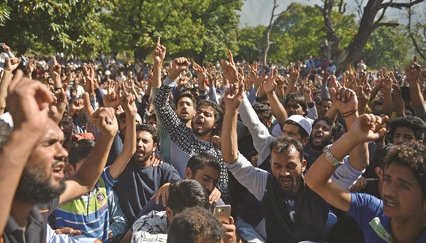Mourners shout slogans near the body of Nasir Shafi, during his funeral in Srinagar yesterday. Shafi was critically injured in pellet gun firing by security forces during a protest and later died of his injuries, sparking protests and renewed clashes in Srinagar.