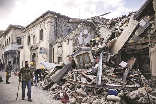 A man walking amidst rubble following an earthquake in Amatrice, central Italy, on August 24.