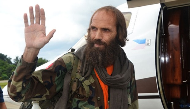 Freed Norwegian national Kjartan Sekkingstad waves as he prepares to board a plane