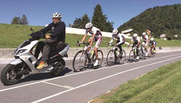 Qatar national cycling team coach Tareq Esmaili leads his riders during a summer training camp.