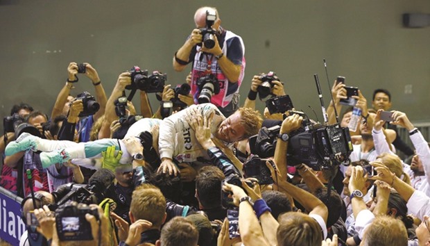 Mercedesu2019 Nico Rosberg celebrates winning the Singapore Grand Prix yesterday. (Reuters)
