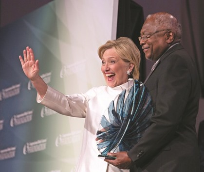 Democratic Presidential nominee Hillary Clinton waves as she accepts a Phoenix Award from Representative Jim Clyburn (D-SC) during the Congressional Black Caucus Foundationu2019s Phoenix Awards Dinner in Washington, DC.