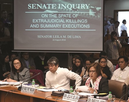 File photo shows Senate Committee on Human Rights Chairperson Senator Leila De Lima (right) speaking at the start of a senate inquiry into a spate of extra-judicial killings in Manila.