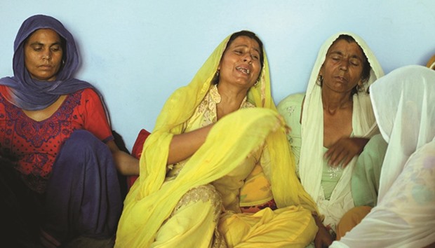 Geeta (in yellow), wife of Ravi Paul, a soldier who was killed in Sundayu2019s attack at an army base in Uri, mourns at her house in Sarwa village in Samba district, south of Jammu, yesterday.