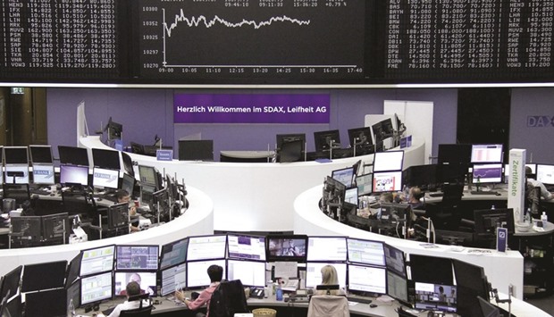 Traders work at the Frankfurt Stock Exchange. The DAX 30 jumped 0.95% at 10,373.87 points yesterday.