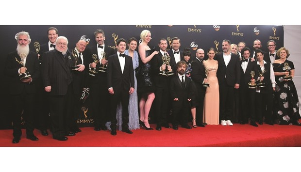 Cast & crew of Game of Thrones pose with the Emmy for Outstanding Drama Series.
