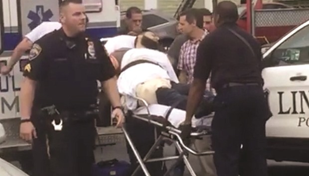 Policemen place in an ambulance a man they identified as Ahmad Khan Rahami, who is wanted for questioning in connection with an explosion in New York City.