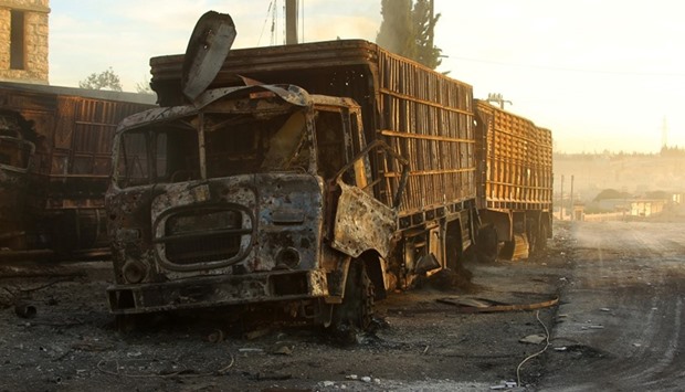 Damaged aid trucks are pictured after an airstrike on the rebel held Urm al-Kubra town, western Aleppo city, Syria