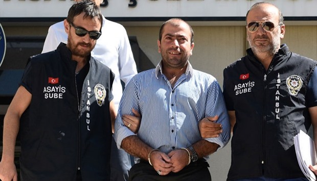 An Istanbul court on Monday placed Abdullah Cakiroglu (C) under arrest ahead of the trial
