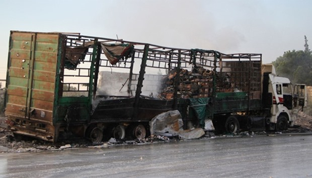 A damaged truck carrying aid is seen on the side of the road