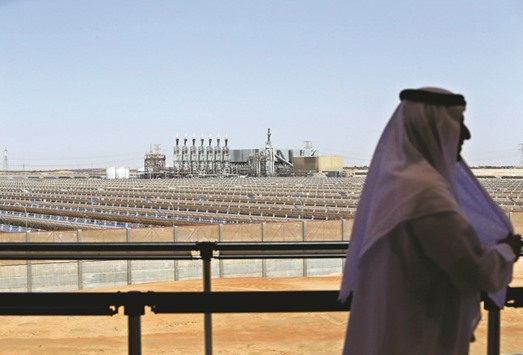 An Emirati man stands on a balcony overlooking the Shams 1, Concentrated Solar power (CSP) plant, in Al-Gharibiyah district on the outskirts of Abu Dhabi (file). The UAE, where Abu Dhabi is the capital, is seeking to diversify its energy supply away from natural gas, which fuels most of its power plants.