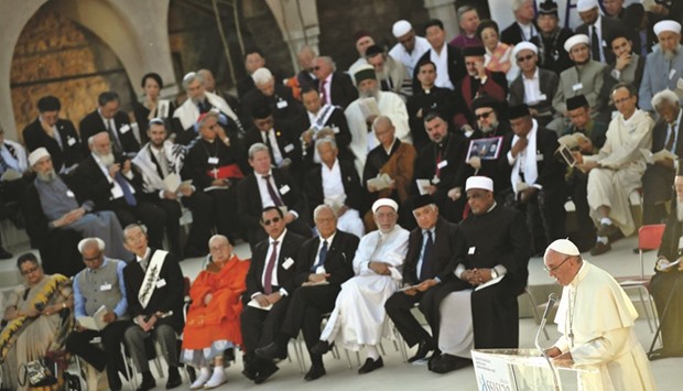Pope Francis reads his speech in front of representatives from different religious traditions at the St Francis Basilica in Assisi yesterday. Francis denounced those who wage war in the name of God, as he met faith leaders and victims of war to discuss growing religious fanaticism and escalating violence around the world.