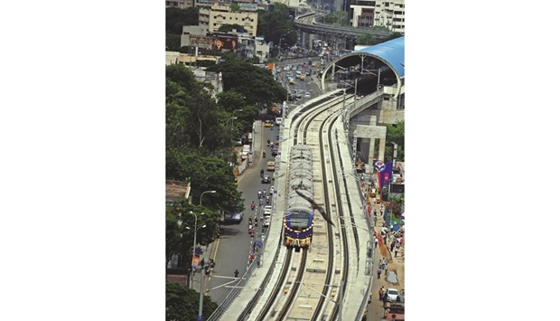A Chennai Metro Rail train travels along the track between the airport and Little Mount yesterday.