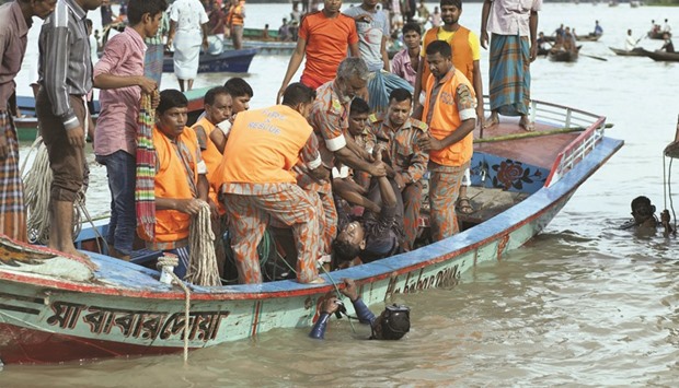 Rescue workers lift a recovered body onto a boat after an overcrowded ferry sank in southern Barisal district yesterday.