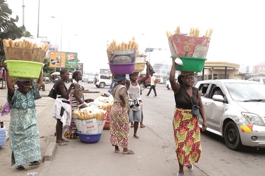 Congolese vendors carry bread for sale in Kinshasa yesterday.