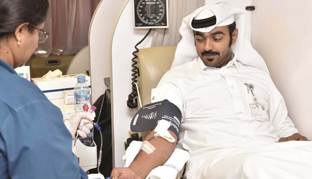 A QNB employee donating blood.
