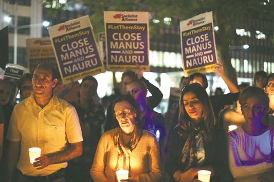 An April 30, 2016, file photo of a candle light vigil in Sydney for an Iranian refugee who died after setting himself on fire on Nauru.