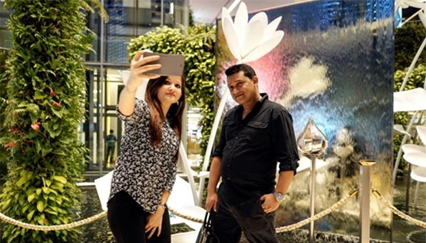 Tourists take a selfie at a department store in Bangkok.