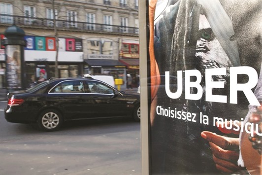 An advertisement for the Uber car and ride-sharing service is displayed on a bus stop in Paris. Chinau2019s  Ministry of Commerce said at a briefing yesterday it was probing Didi Chuxingu2019s planned acquisition of the US rivalu2019s China unit and Comcast Corpu2019s proposed purchase of movie studio DreamWorks Animation.
