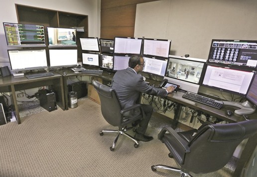 A doctor remotely monitors live footage of patients inside an electronic intensive care unit (eICU) at Fortis hospital in New Delhi.