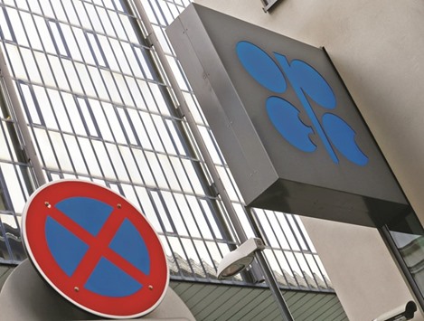 The Opec logo is pictured behind a traffic sign at its headquarters in Vienna. Opecu2019s 14 members will hold talks on September 28 in Algiers to address a global supply glut that led prices to drop by more than half from their 2014 peak.